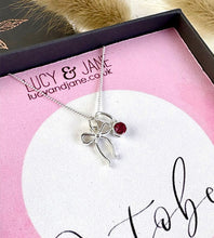 Load image into Gallery viewer, sterling sivler bow necklace with a pretty pink stone to represent October birthstone tourmaline