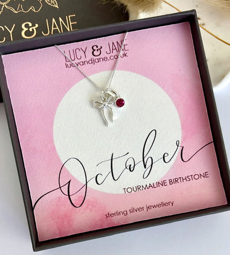 sterling silver bow birthstone necklace.  Pretty bow necklace with a sparkly pink tourmaline birthstone