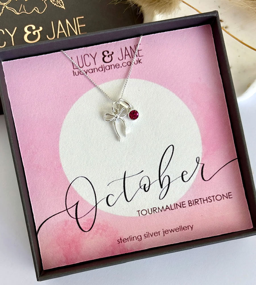 sterling silver bow birthstone necklace.  Pretty bow necklace with a sparkly pink tourmaline birthstone