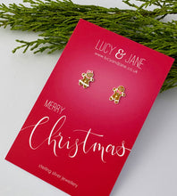 Load image into Gallery viewer, mismatched sterling silver gingerbread man and woman earrings on a Merry Christmas card