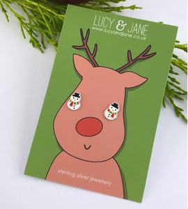 sterling silver snowman stud earrings on a  fun Christmas backing card.  Snowmen earrings are white with a green and red scarf and a black hat