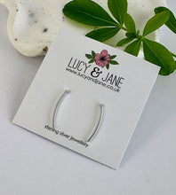 Load image into Gallery viewer, sterling silver curved bar earrings on a white Lucy and Jane backing card