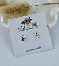 Load image into Gallery viewer, Pair of black and white sterling silver dog-shaped earrings for children on a Lucy &amp; Jane card with decorative elements.