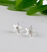 Load image into Gallery viewer, sterling silver diamond cut star studs with a tiny clear crystal at the centre of each earring.  Post and butterfly backs.