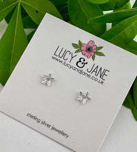 Load image into Gallery viewer, sterling silver star studs that are diamond cut to catch the light. Feature a small clear crystal at the centre. Displayed on a Lucy and Jane earring card.