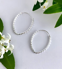 Load image into Gallery viewer, sterling silver teardrop shaped hoops on a plain white background