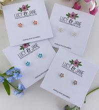 Load image into Gallery viewer, four pairs of tiny sterling silver daisy studs in different colours - white, pink, blue and purple
