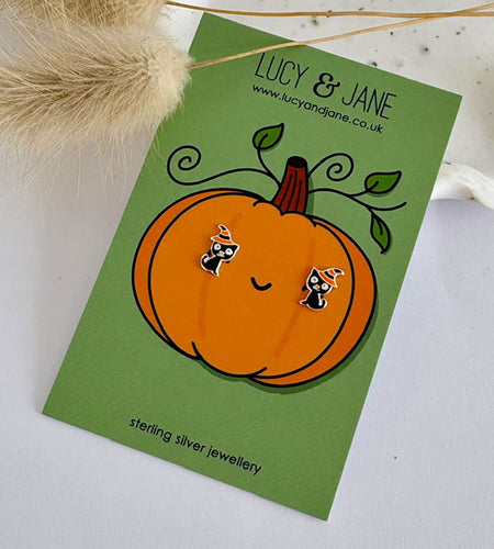 sterling silver black cat earrings wearing a witches hat and displayed on a Halloween themed backing card.