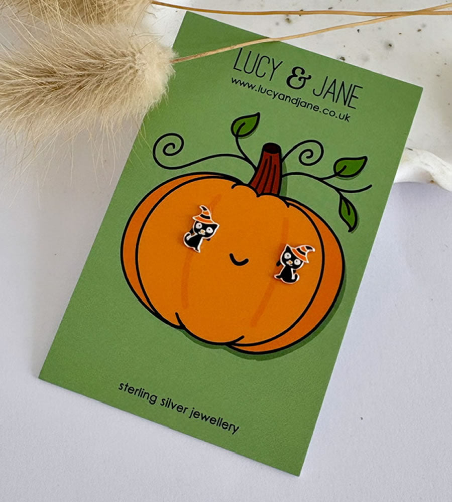 sterling silver black cat earrings wearing a witches hat and displayed on a Halloween themed backing card.