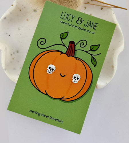 sterling silver skull earrings for goth or Halloween style.  On a pumpkin design halloween backing card.