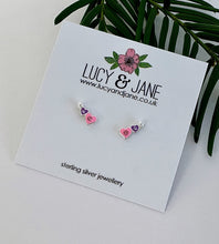 Load image into Gallery viewer, Small sterling silver heart stud earrings in pink and purple finished off with a tiny white pearl. Displayed on a Lucy and Jane jewellery card.