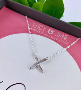 close up of the kiss necklace in sterling silver
