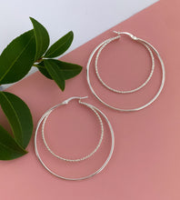 Load image into Gallery viewer, large sterling silver double hoops.  One smaller textured hoop inside a larger smooth silver hoop
