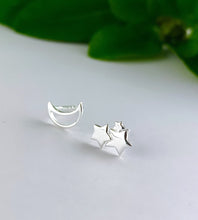 Load image into Gallery viewer, sterling silver pair of mismatched earrings with one open moon and one cluster of stars