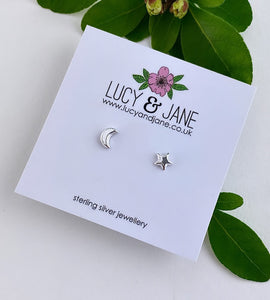 sterling silver mismatched moon and star studs on a white card