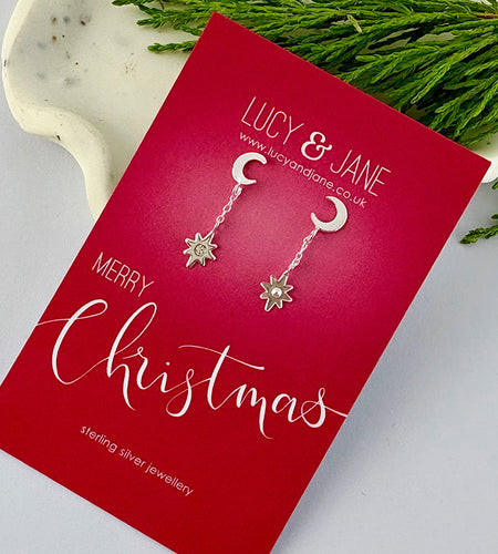 sterlig silver moon earrings with a small star hanging down.