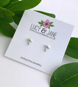 sterling silver toadstool studs on a white branded backing card