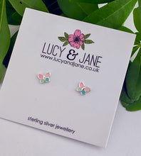 Load image into Gallery viewer, A pair of small butterfly stud earrings for children with pretty pastel pink, mint green, and blue wings on sterling silver, displayed on Lucy and Jane earring card.