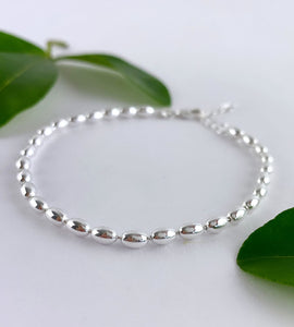 close up detail of sterling silver seed bracelet