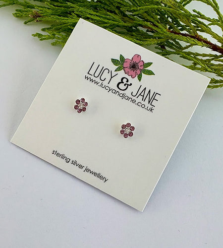 small sterling silver sparkly purple flower studs on a Lucy and Jane card