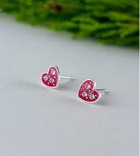 Load image into Gallery viewer, Heart-shaped earrings with pink enamel and clear stones on a light gray background.