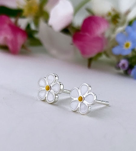 sterlnig silver small white enamel daisy studs with a tiny yellow centre.  Good studs for children