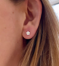 Load image into Gallery viewer, example of tiny daisy sterlig silver and white studs in model&#39;s ear