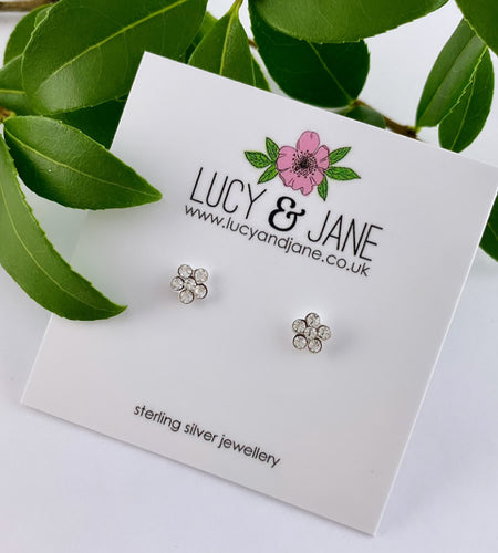 small sparkly flower sterling silver studs on a plain white backing card