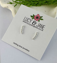 Load image into Gallery viewer, sterling silver sparkly curved bar earrings on a Lucy and Jane card