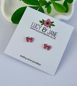 pink sparkly bow earrings on  a Lucy and Jane backing card