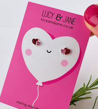 Load image into Gallery viewer, pink and red sterling silver heart studs for children on a cute heart shaped balloon backing card and the branding Lucy and Jane