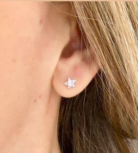 sterling silver sparkly star studs in models ear