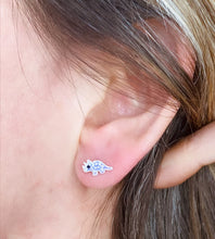 Load image into Gallery viewer, sterling silver sparkly purple triceratops studs in a model&#39;s ear