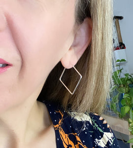 large square hoops on model's ear