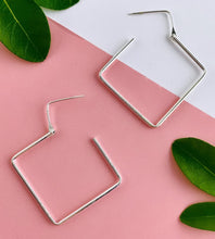Load image into Gallery viewer, sterling silver large square hoops with the opening to show how they go in the piercings