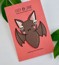 Load image into Gallery viewer, sterling sivler star and skull small dangly earrings on a Halloween themed earring card branded with Lucy and Jane