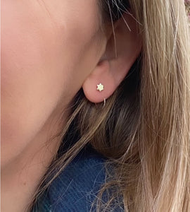 sterling silver star pull through earring on a models ear