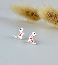 Load image into Gallery viewer, sterling silver t-rex dinosaur stud earrings with some orange detail and their body and cute faces