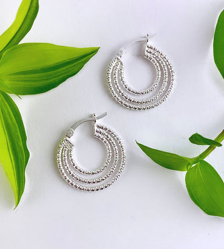 pair of sterling silver hoop earrings that have three hoops attached to each earring.  Hoops are hammered to create an interesting texture.  Approx 20mm