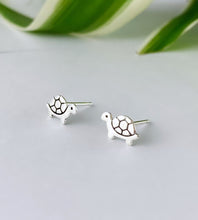 Load image into Gallery viewer, Sterling Silver small turtle earrings on a light gray background