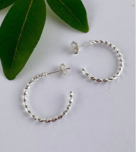 Load image into Gallery viewer, medium size sterling silver twist hoops. Easy to wear half hoops that have a simple post and butterfly back