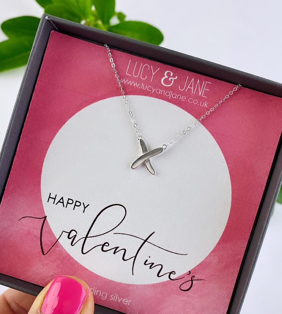 sterling silver kiss necklace in a gift box with a valentines message card