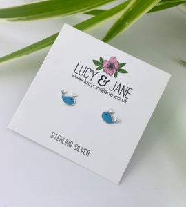 stlering silver blue whale earrings on a backing card