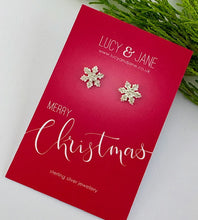 Load image into Gallery viewer, white sterling silver sparkly Snowflake earrings on a red &#39;Merry Christmas&#39; card with &#39;Lucy &amp; Jane&#39; branding.