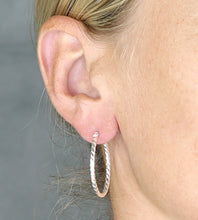 Load image into Gallery viewer, larger sterling silver twist hoops on model