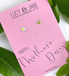 mismatched sterling silver daisy studs and bee studs in yellow and white on a happy mothers day backing card