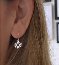 Load image into Gallery viewer, sterling silver snowflake dangly earrings on a model