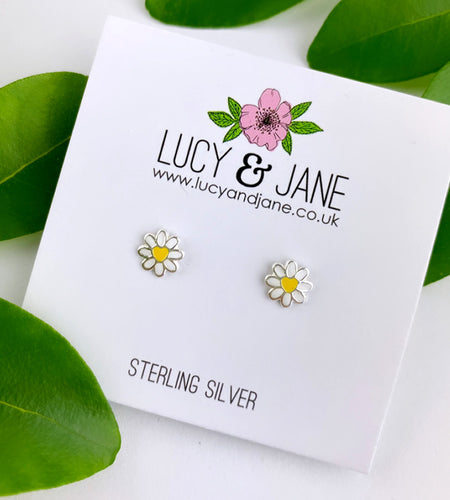 sterling silver daisy studs that are white with a pretty yellow heart centre