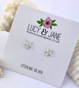 sterling silver starfish studs on a white card
