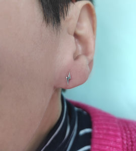 small sterling silver lightning bolt studs on a model's ear